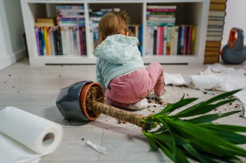 Girl with overturned flower pot